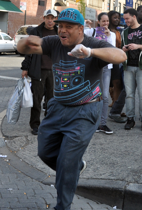 A Fordham pedestrian cheers for Hipolito Mejia