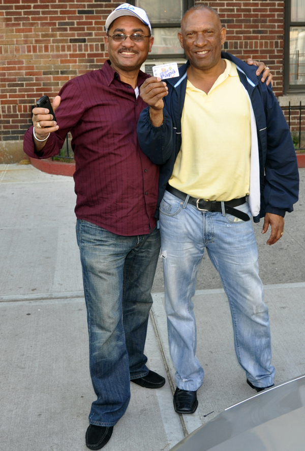 Pedro Julio Escoborg (left) with a supporter on Reservoir Avenue