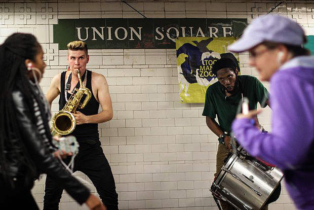 A saxophone-snare drum duo performs in the Union Square.